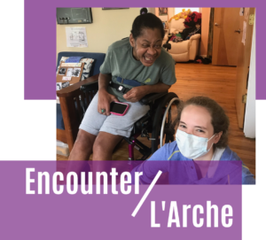 two women smile at the camera, one wearing a mask. Text says Encounter L'Arche