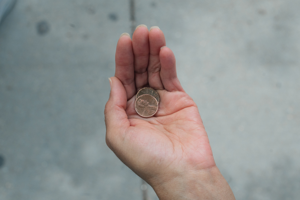 Eileen's hand is palmed upward, gracefully cupping two copper pennies she found on her penny walk.