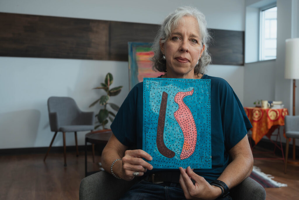 Melissa holds up the drawing Eileen gave her after her mom died. She brought it to share during her sacred stories interview.